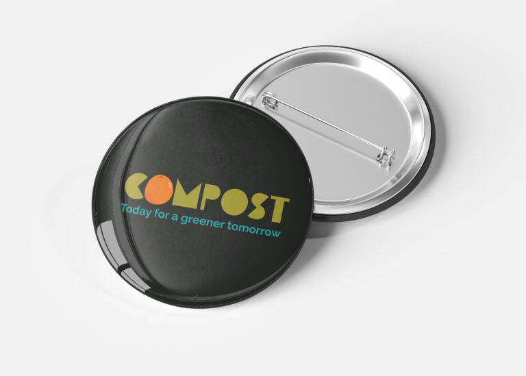 A fron of a button leaning on the back of a button, the button reads "Compost, Today for a greener tomorrow"